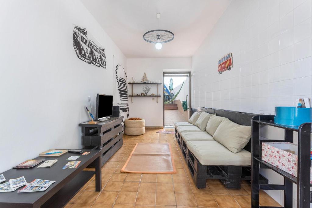 a living room with a couch and a table at Geo House in Vila do Bispo