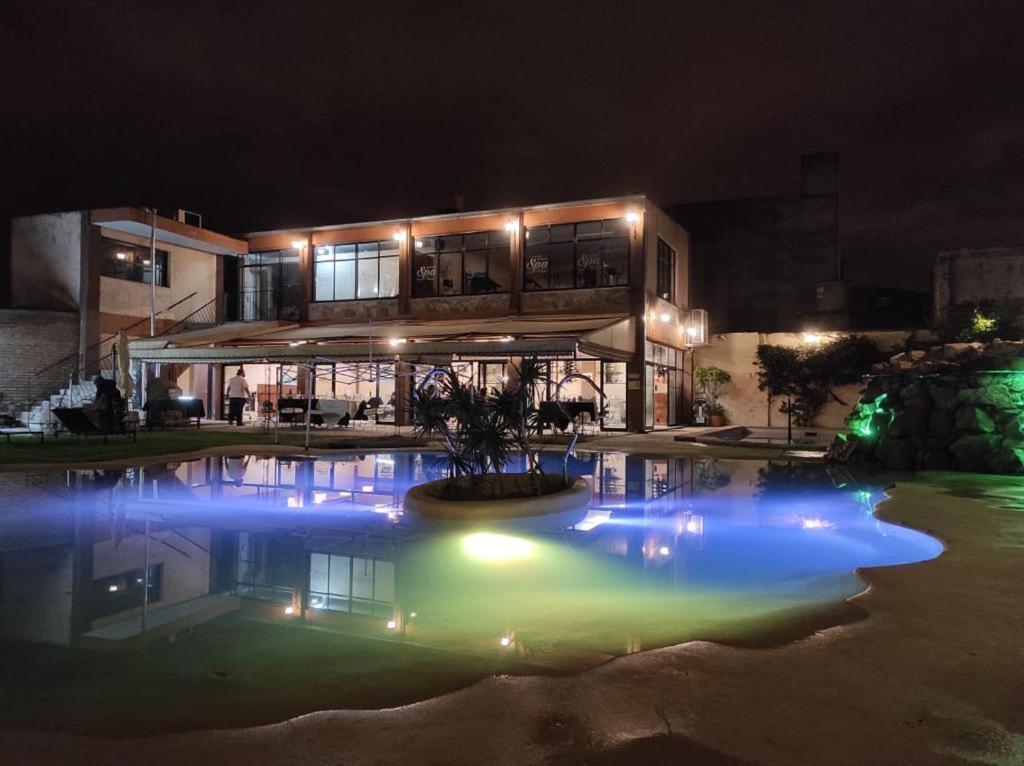 a building with a pool in front of it at night at Hotel Samka in Salta