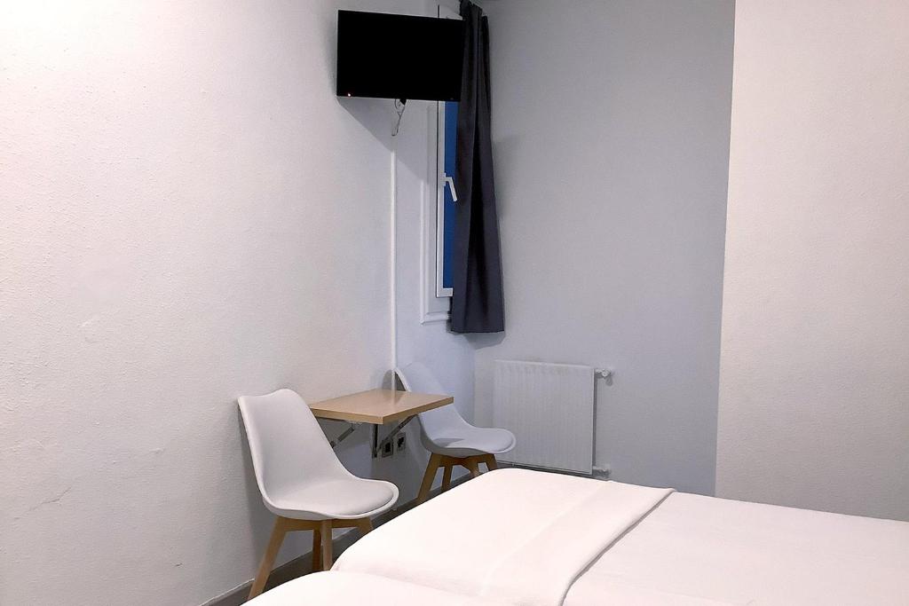Cama o camas de una habitación en Pensión Donostiarra
