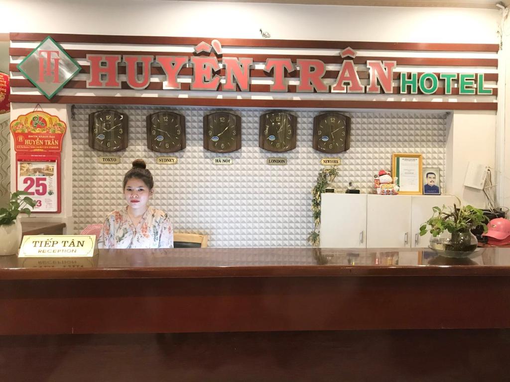 a woman standing behind a counter in a restaurant at Huyen Tran Hotel in Can Tho