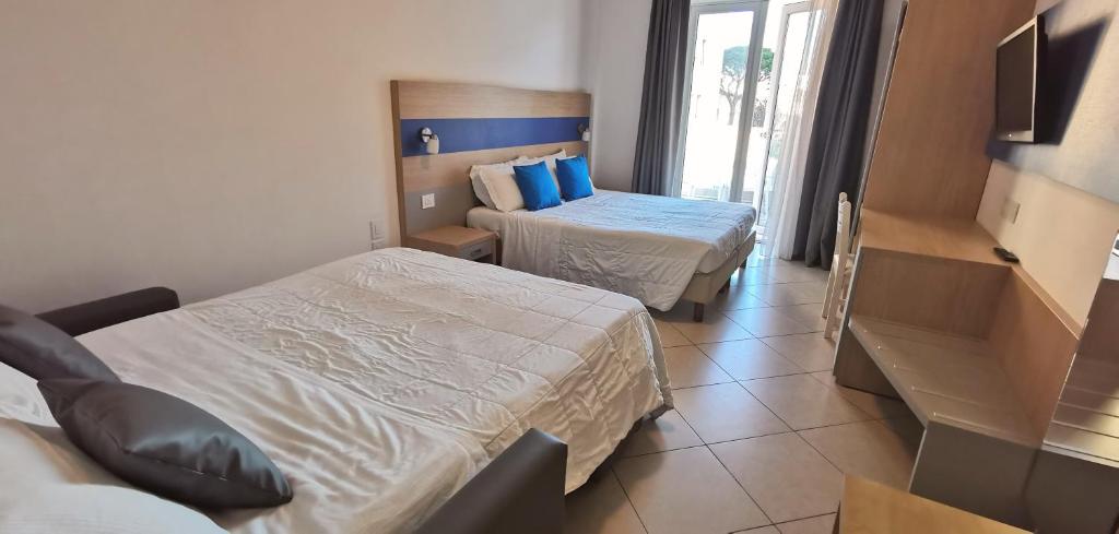 Postel nebo postele na pokoji v ubytování Hotel Oceanomare