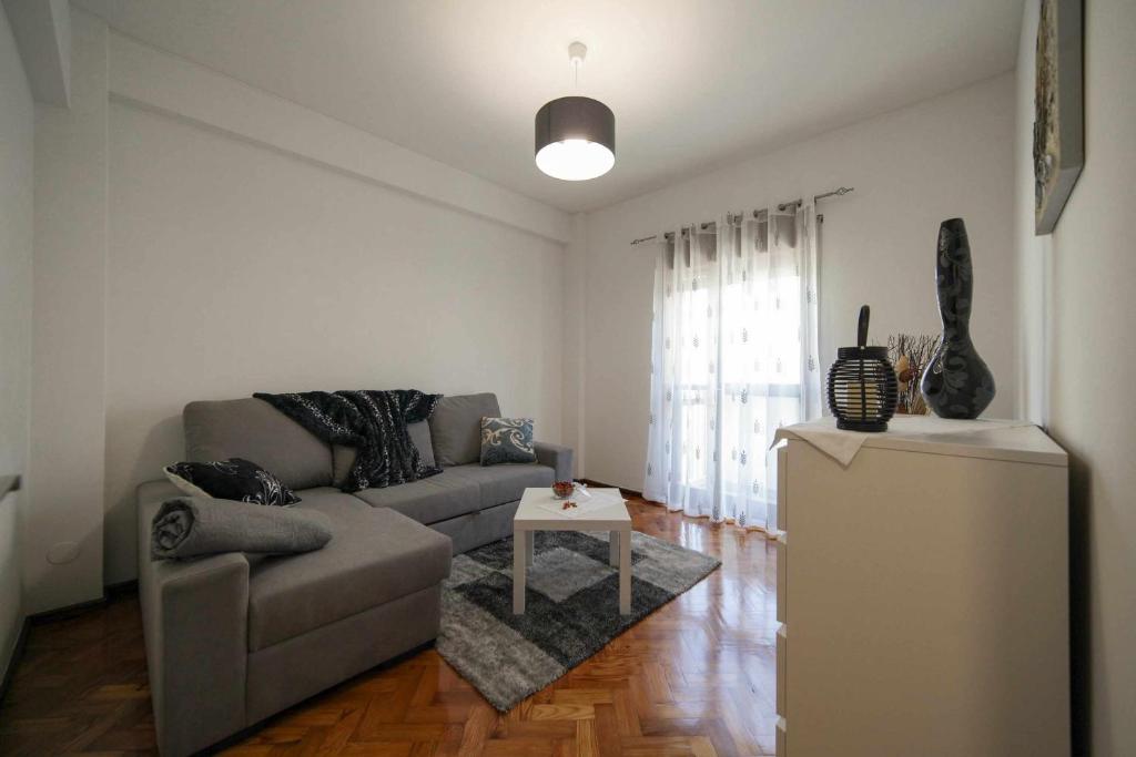 a living room with a couch and a table at Alugabem Apartment Oporto in Porto