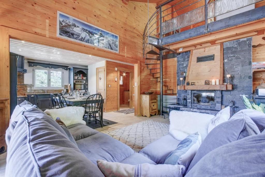 a living room with a couch and a fireplace at CHALET L'GORZON in Morzine