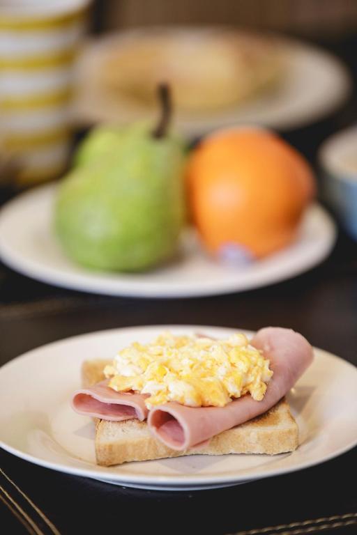 a plate with a sandwich with eggs on it at Hostal Ventisqueros in Punta Arenas