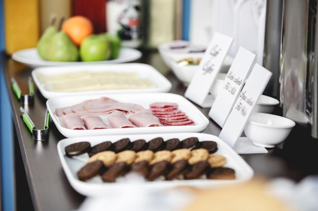 a table with trays of different types of food at Hostal Ventisqueros in Punta Arenas