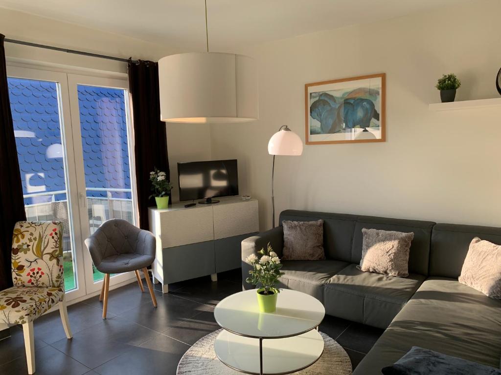 a living room with a couch and a table at Ferienwohnung Rudi Göhren in Göhren