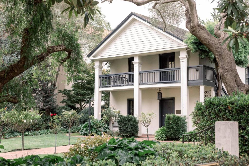 a white house with a balcony on top of it at Merritt House Hotel in Monterey