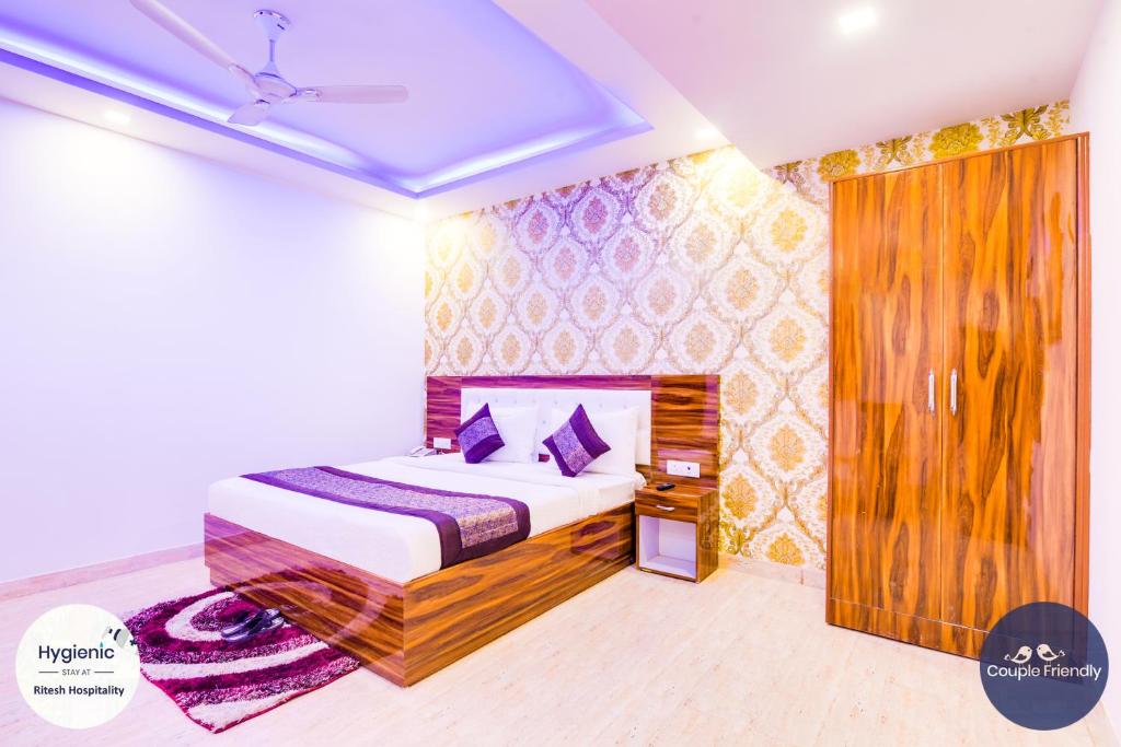 a bedroom with a bed with purple pillows at Hotel Fabulous - Delhi International Airport in New Delhi