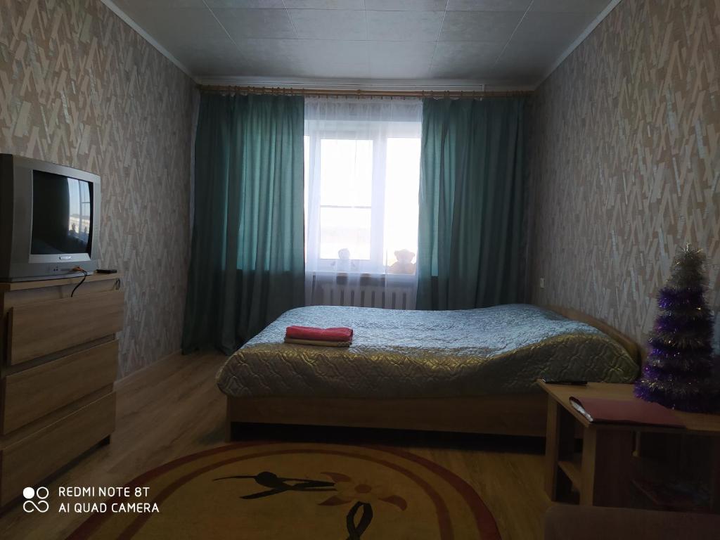 
Кровать или кровати в номере Апартаменты "В гостях у Маши"
