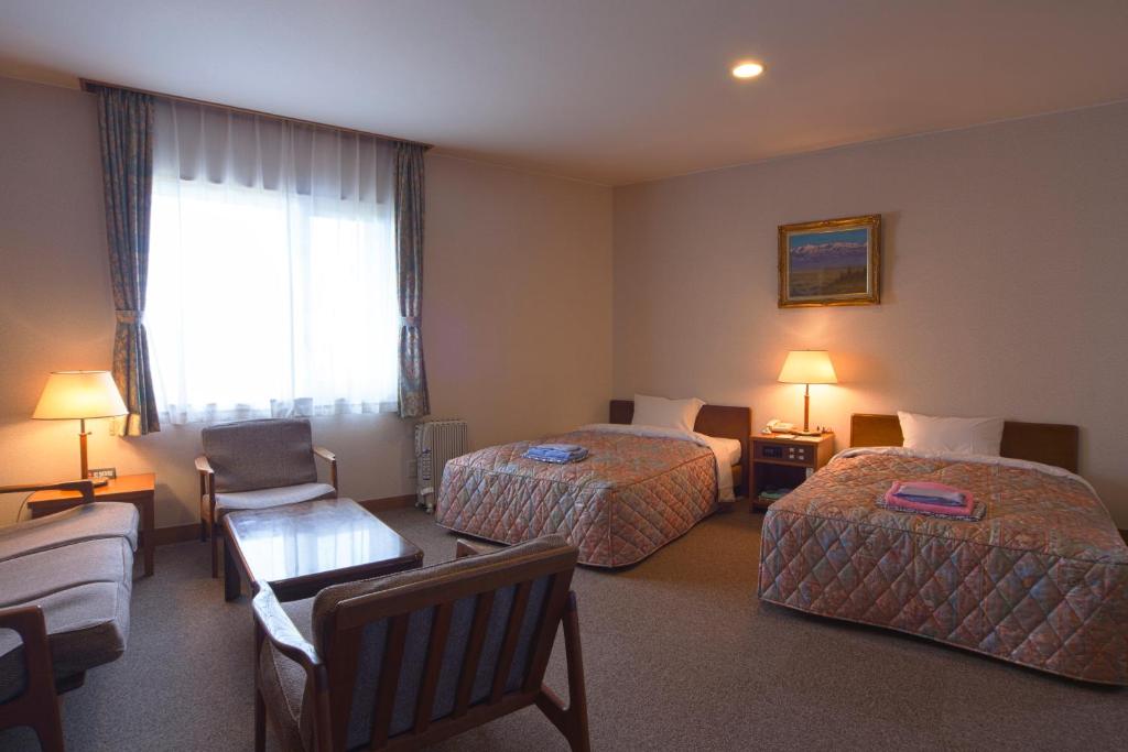 Postel nebo postele na pokoji v ubytování Hotel Tateyama