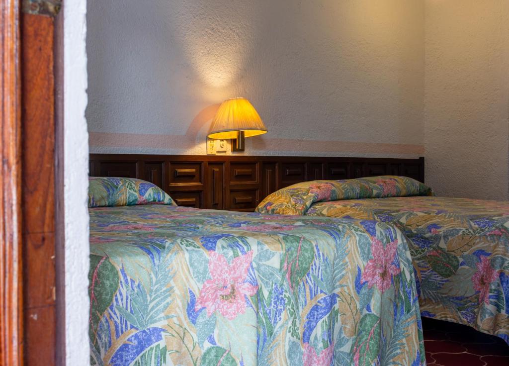 Postel nebo postele na pokoji v ubytování Hotel Delfin