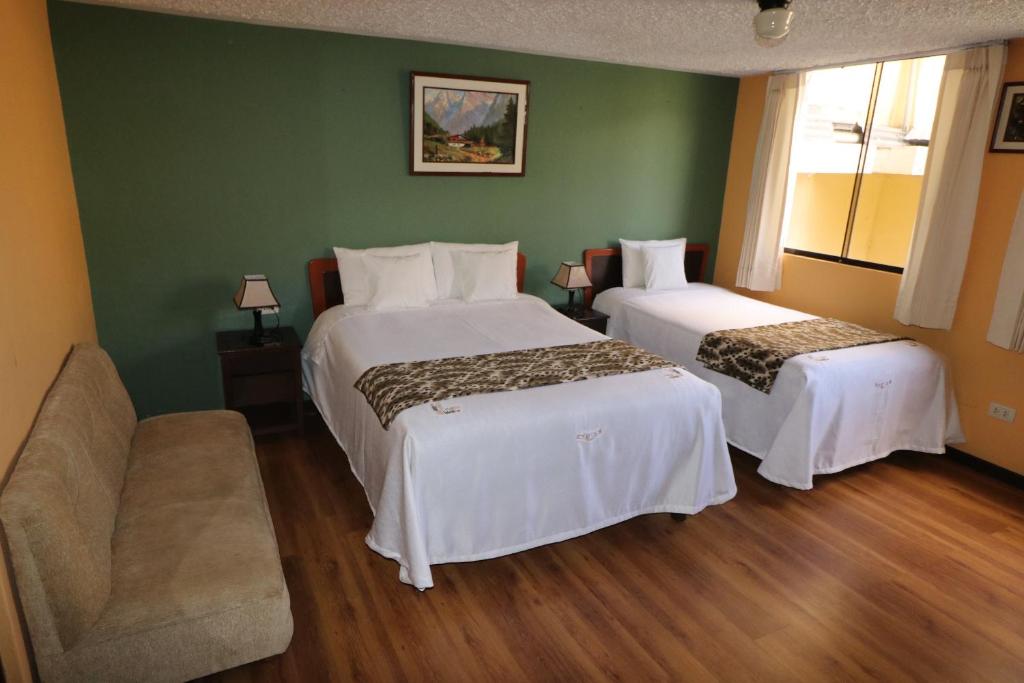 a hotel room with two beds and a couch at La Posada del Colca in Chivay