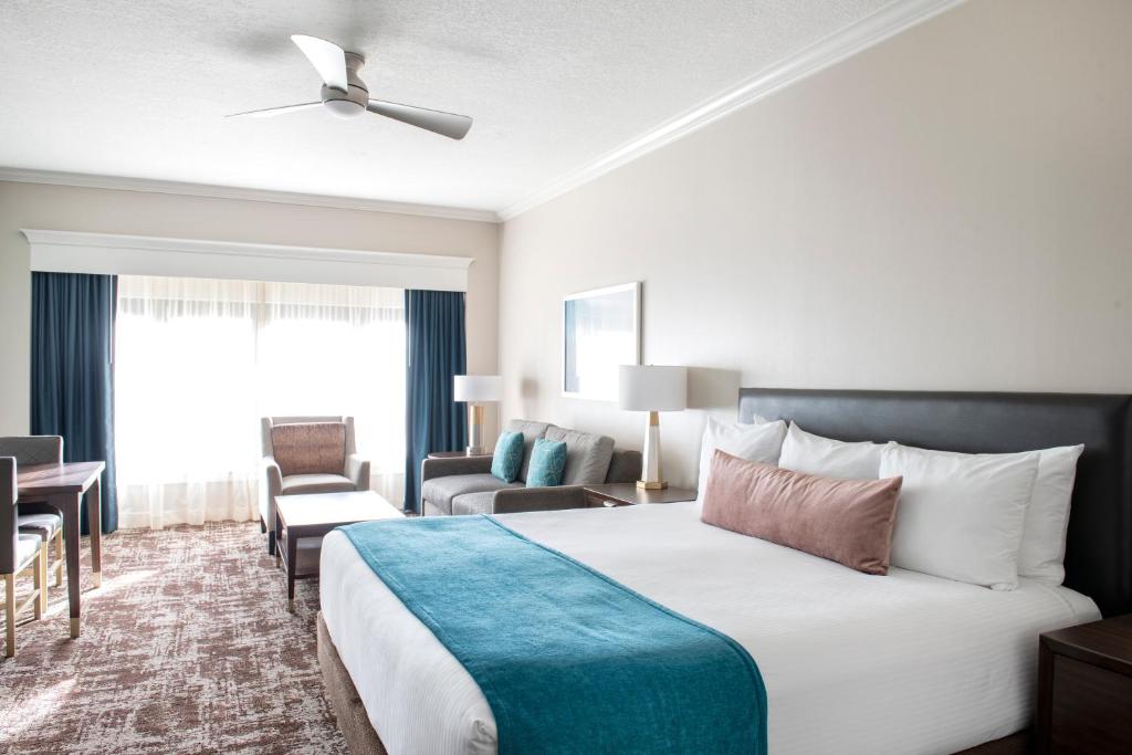 a hotel room with a large bed and a living room at Club Wyndham Harbour Lights in San Diego
