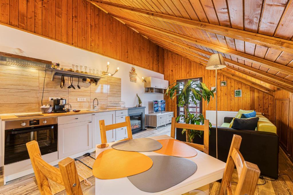 a kitchen and dining room with a table and chairs at Snug Apartments - Private Parking near DownTown in Braşov