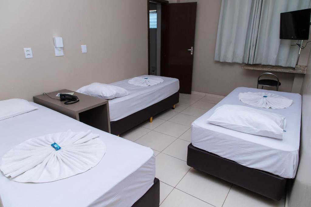 Postel nebo postele na pokoji v ubytování Hotel Astória Maringá