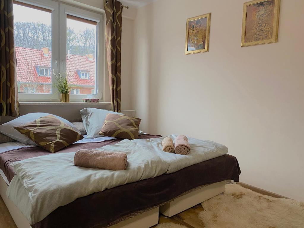 a bed in a room with two stuffed animals on it at Swish Apartment in Gdańsk