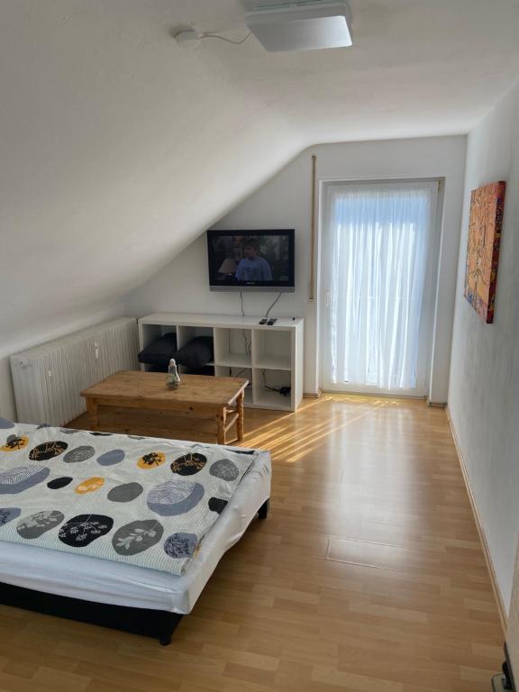 a bedroom with a bed and a table in it at Apartment – Wohnung bei Nürnberg #2 in Röthenbach an der Pegnitz