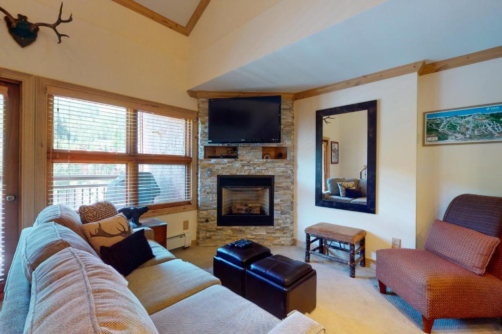 a living room with a couch and a fireplace at Lion Square Lodge South 554 in Vail