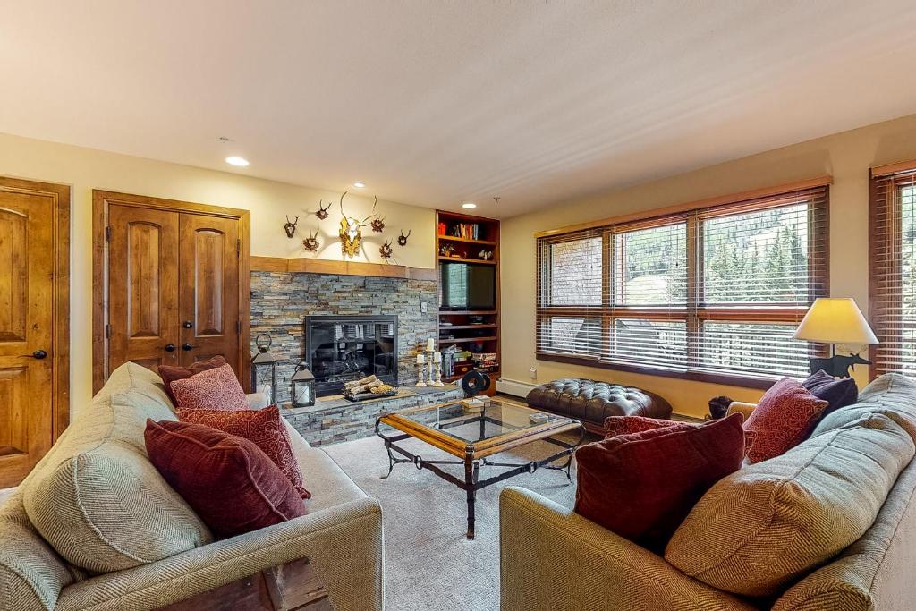 a living room with two couches and a fireplace at Lion Square Lodge South 550 in Vail