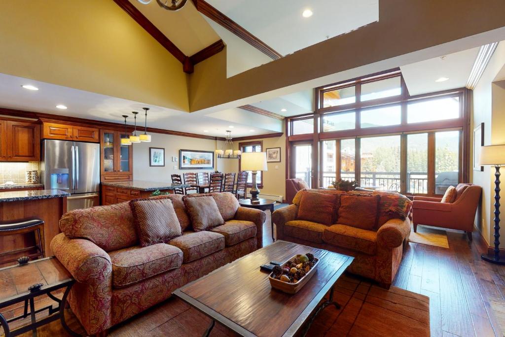 a living room with two couches and a table at Lion Square Lodge East 313 in Vail