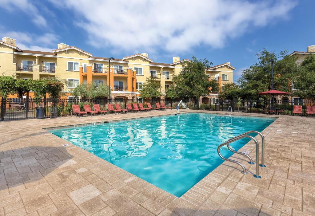 una piscina en un hotel con sillas y apartamentos en condominio en Vino Bello Resort, en Napa
