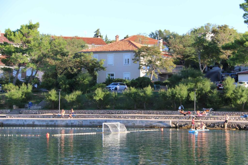 a body of water with people swimming in it at Apartment Silo 19 in Šilo