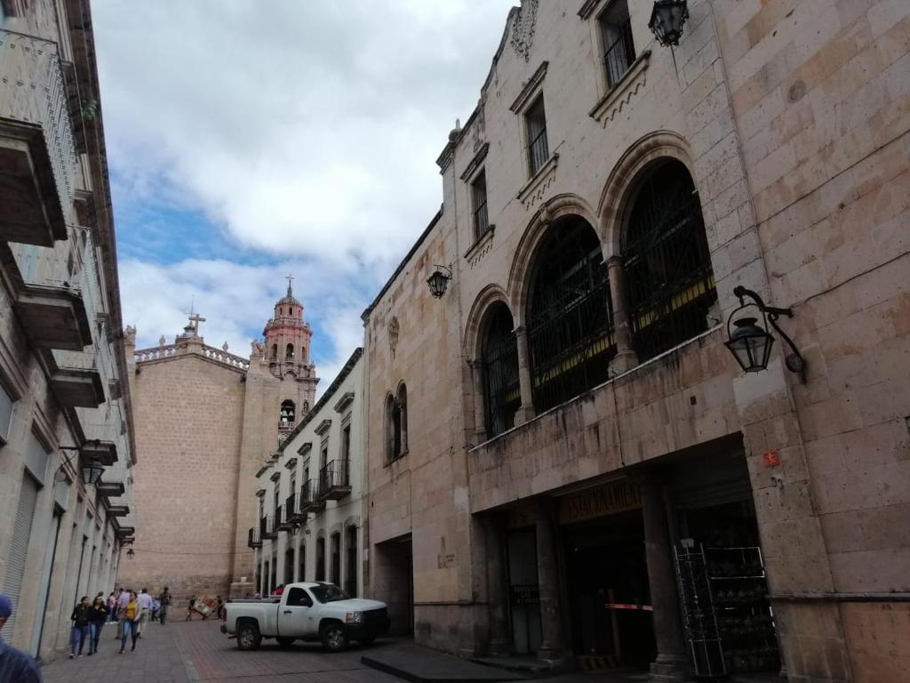 a truck parked on a street next to a building at Estancia Real in Morelia