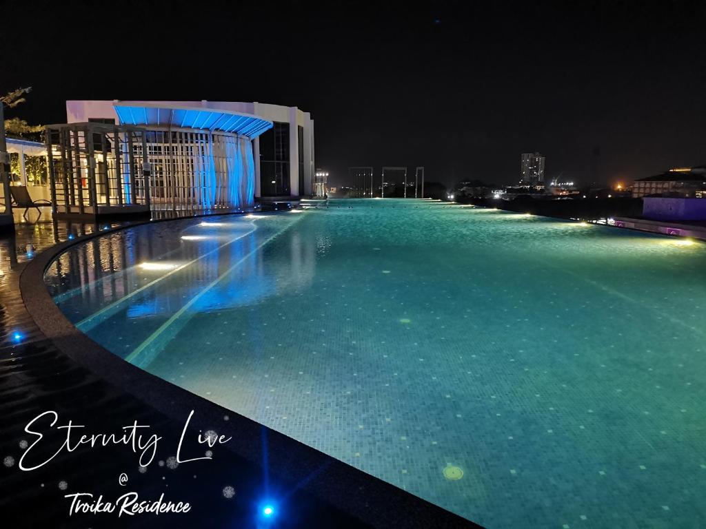 a large swimming pool at night on a building at Troika Residence Kota Bharu @ Eternity Live-1B4pax in Kota Bharu