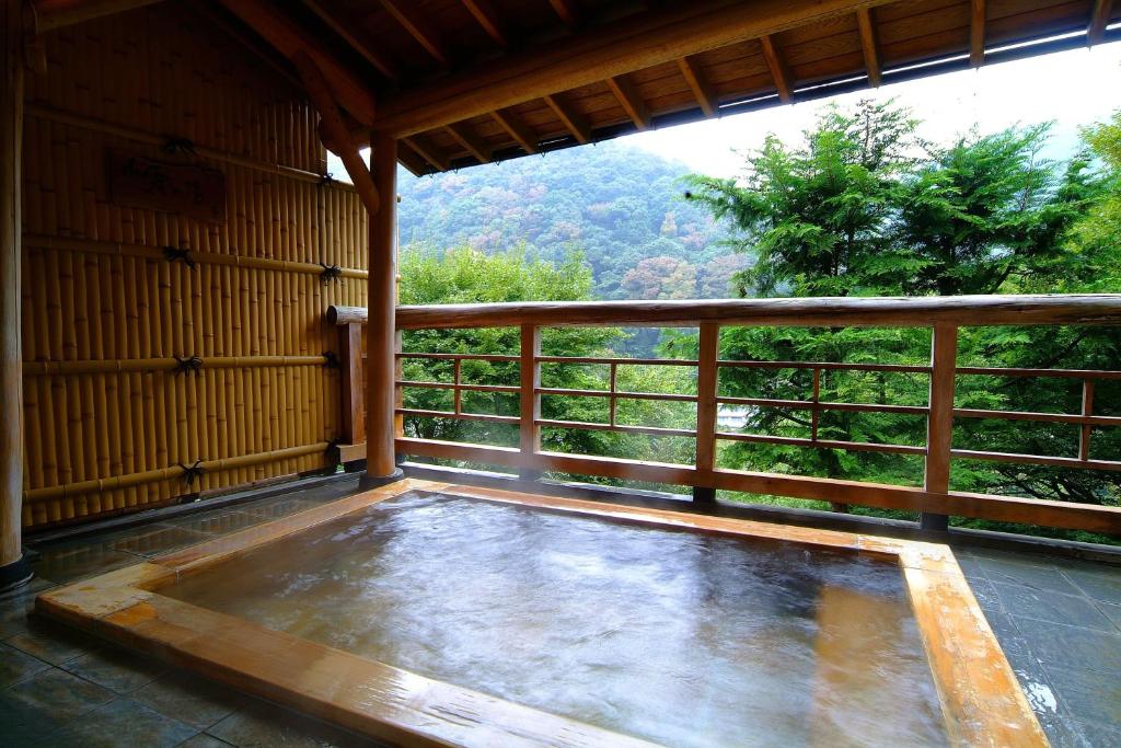 a large pool of water with a large window at Hatago Kintoen in Hakone