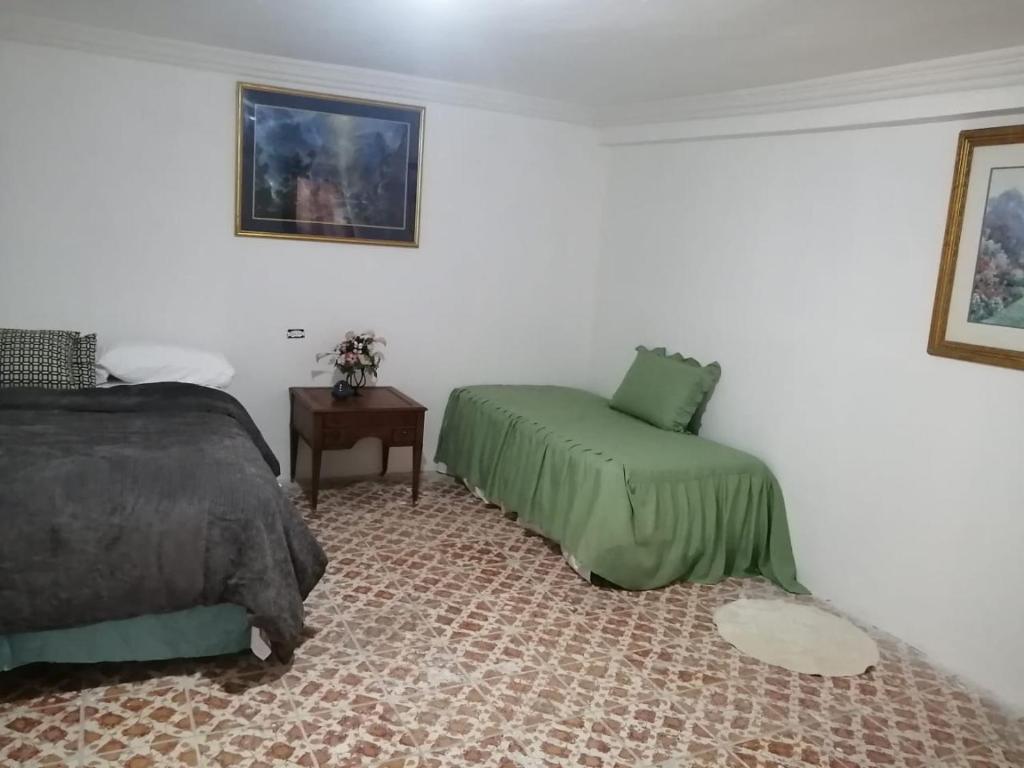 a bedroom with a bed and a chair in it at Brenda Alicia 2 in Puerto Peñasco