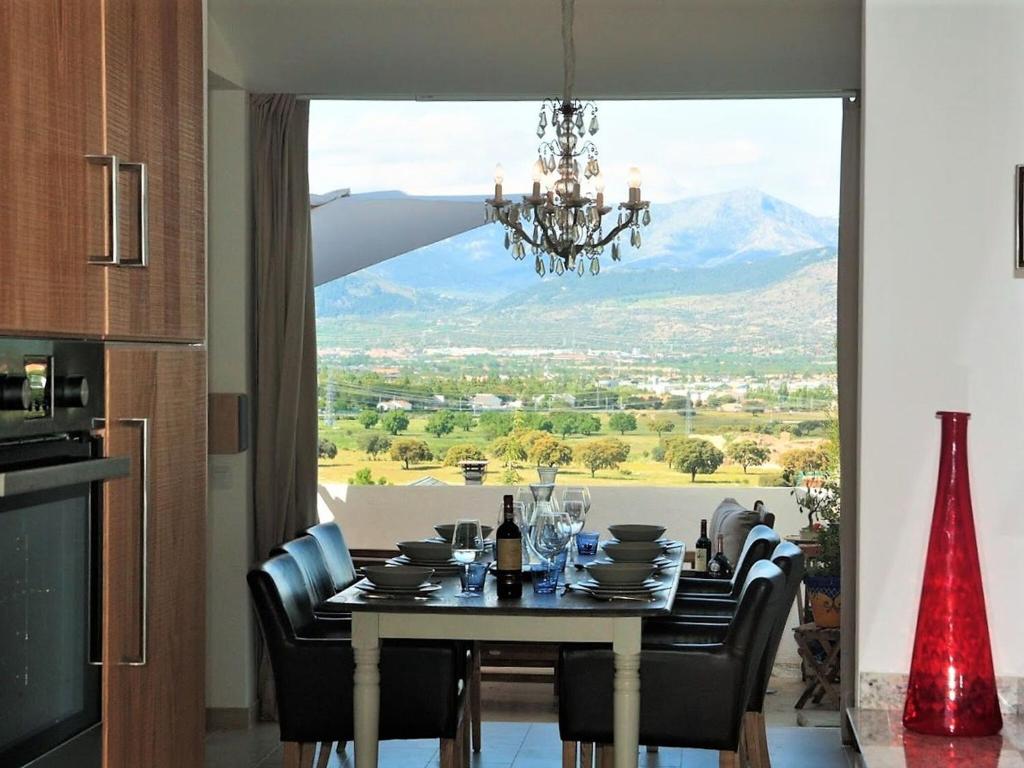 a dining room table with a view of a mountain at Belvilla by OYO Casa Alegr a in Galapagar