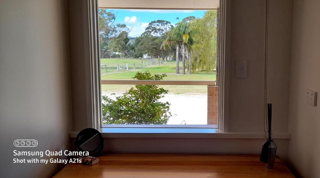 a window with a view of a house at 101 Oatlands in Mount Barker
