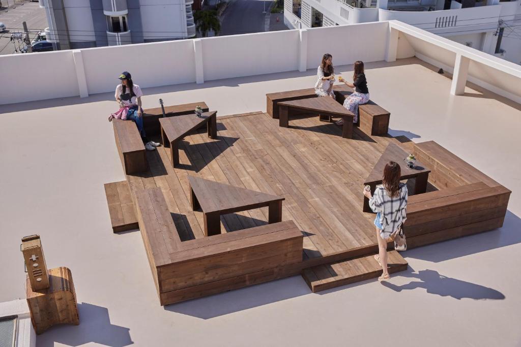 a group of people sitting on top of a roof at HOTEL tuka miika in Ishigaki Island