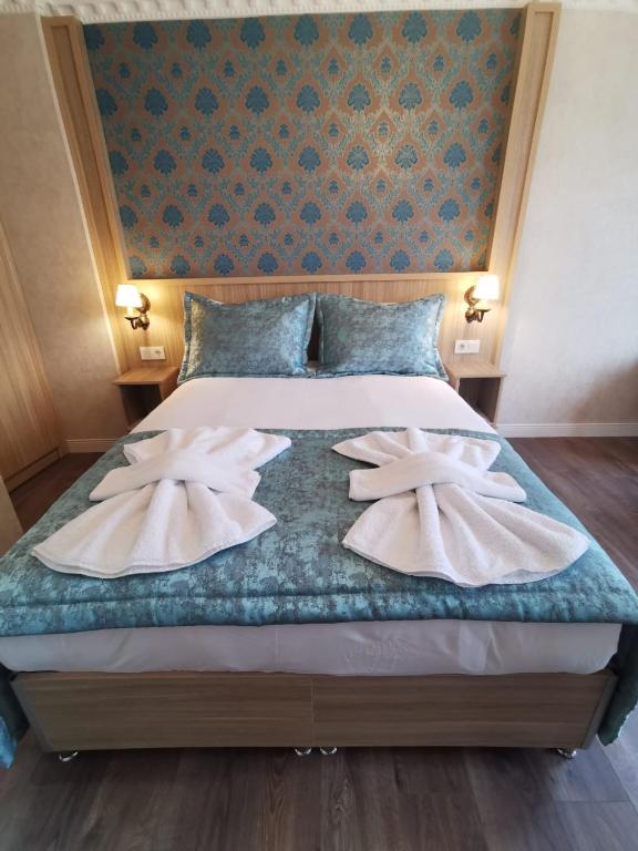 A bed or beds in a room at Agora Boutique Hotel & Bistro
