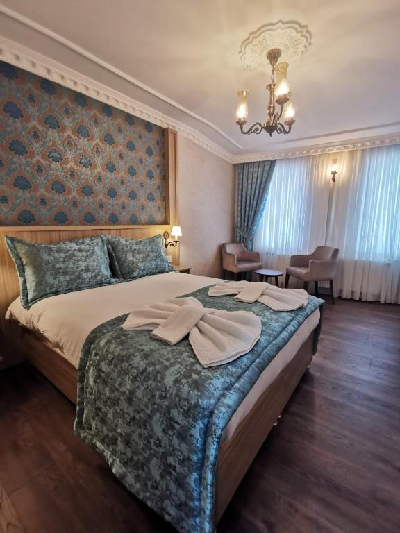 A bed or beds in a room at Agora Boutique Hotel & Bistro