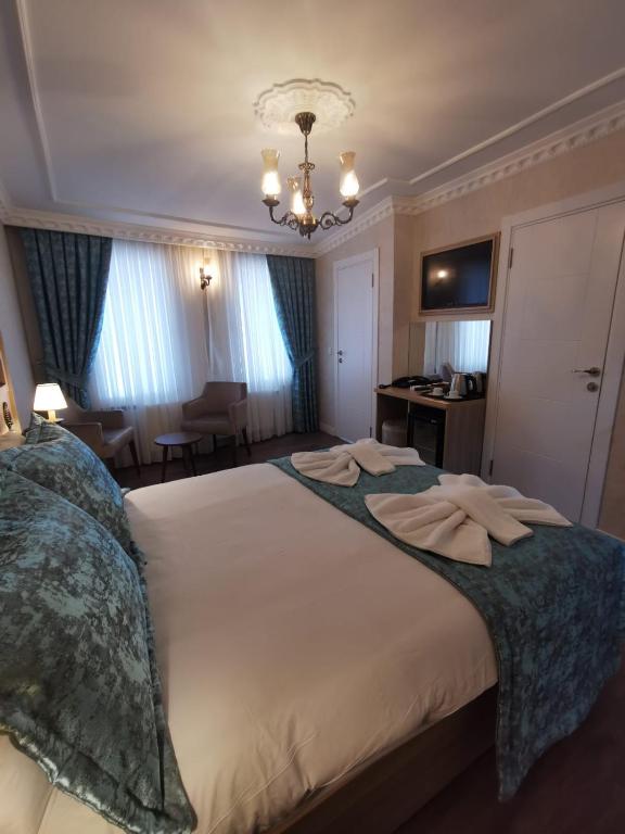 A bed or beds in a room at Agora Boutique Hotel & Bistro