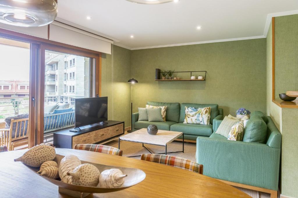 TV a/nebo společenská místnost v ubytování P18 Villalia Apartamento B en la Isla de la Toja