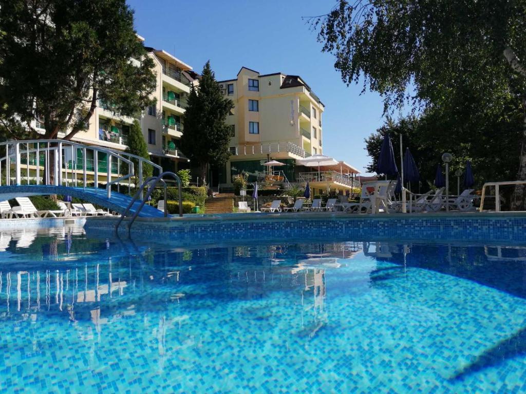 a large swimming pool with a slide in a building at Hotel Silver - All Inclusive & Free Parking in Golden Sands
