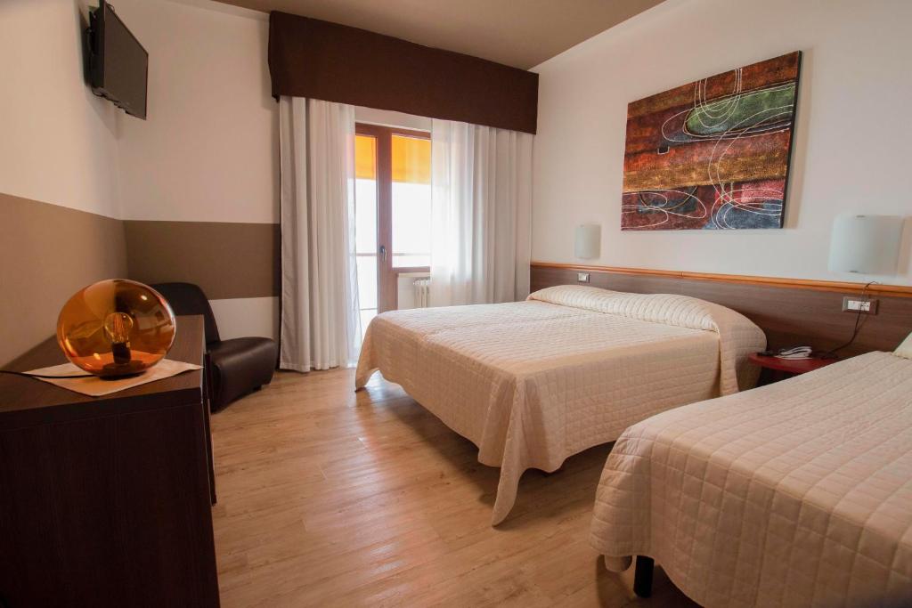 Postel nebo postele na pokoji v ubytování Hotel San Zeno