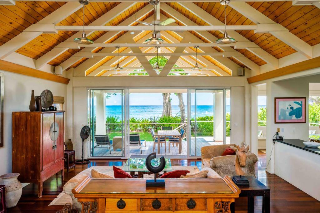 a living room with a coffered ceiling and a table at Makana Akua Haena home in Haena