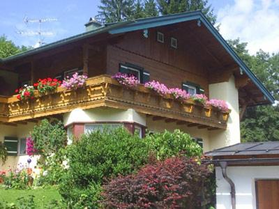 une maison avec un balcon fleuri dans l'établissement Ferienwohnung Kahlersberg, à Schönau am Königssee