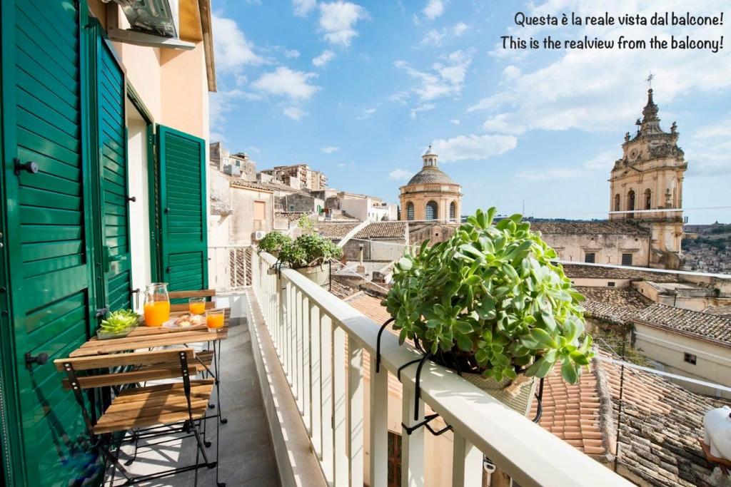a balcony with a table and a view of the city at Casa Vacanze La Meridiana in Modica
