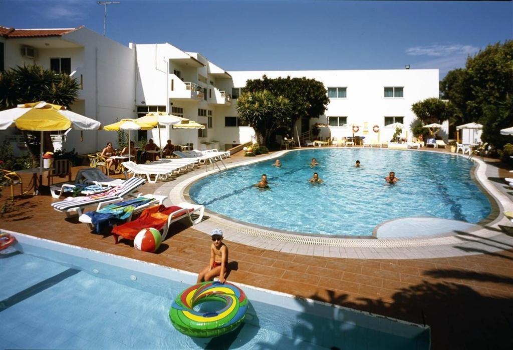 a group of people in a swimming pool at Asterias Bay-Theologos in Theologos