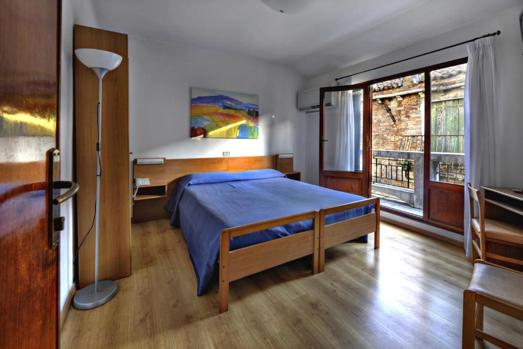 Postel nebo postele na pokoji v ubytování Hotel Caprera