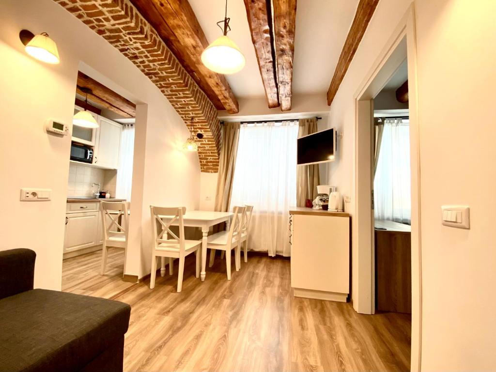 a kitchen and dining room with a table and chairs at CERO Brasov in Braşov