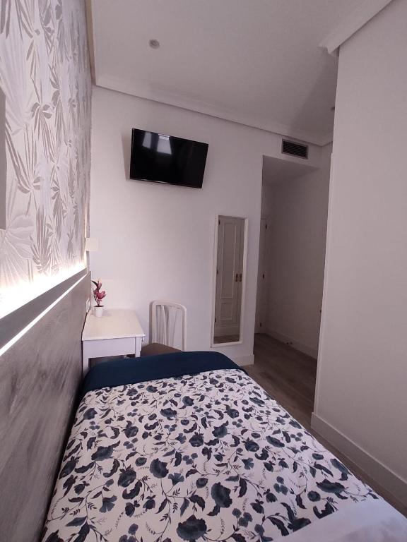 Postel nebo postele na pokoji v ubytování Hostal Alfaro