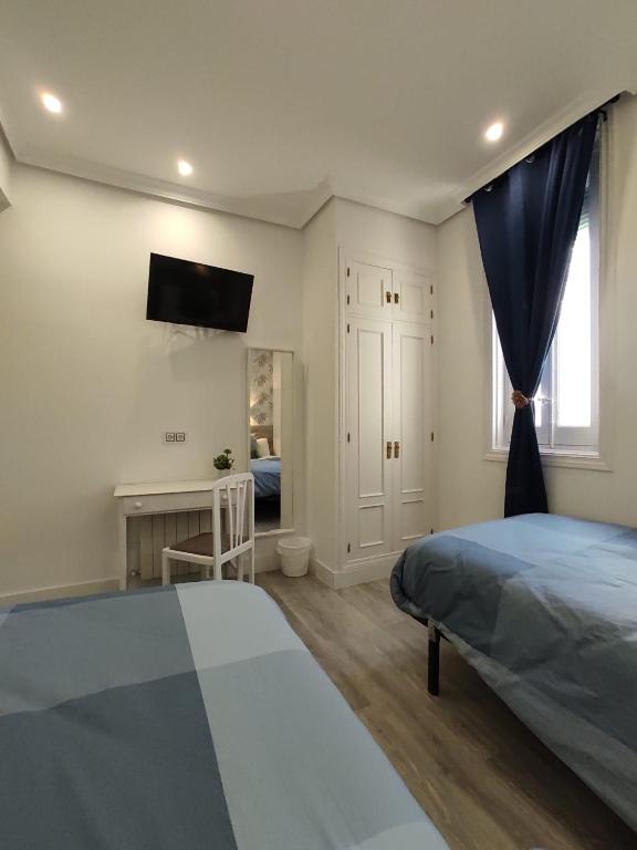 Postel nebo postele na pokoji v ubytování Hostal Alfaro
