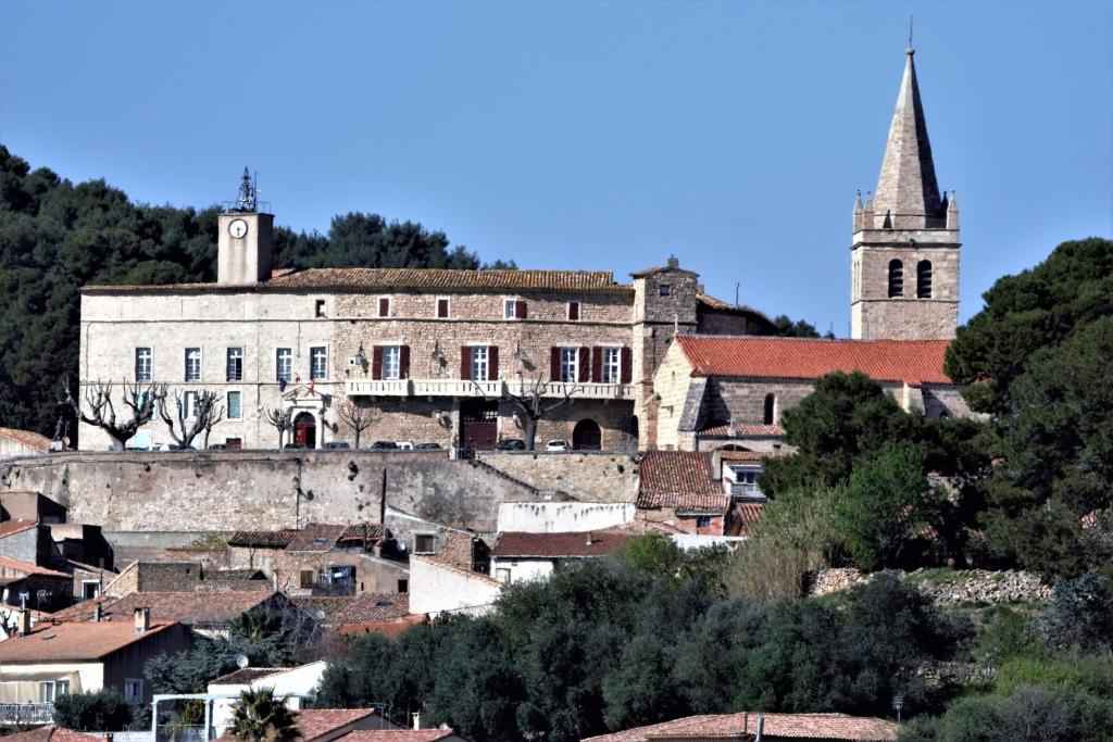 a view of a town with a church at Chateau de Murviel in Murviel