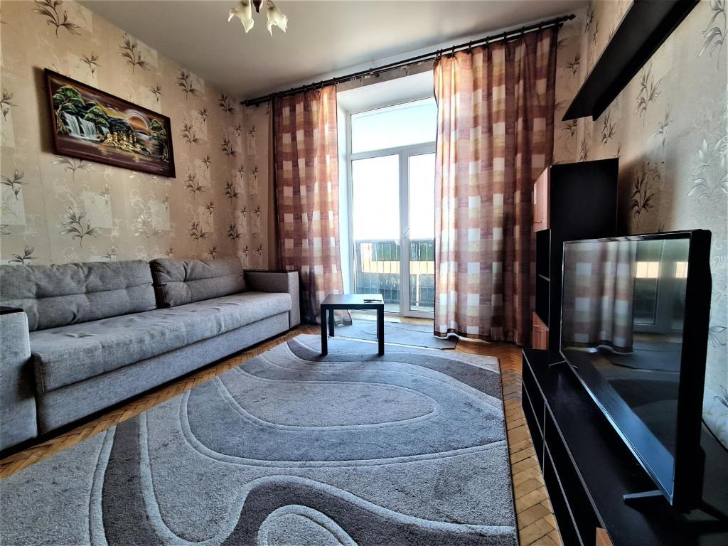 a living room with a couch and a television at Apartments on Lenina in Mogilev