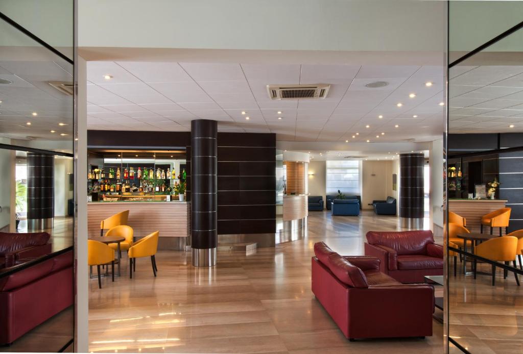 a lobby with a bar in a building at Virgilio Grand Hotel in Sperlonga